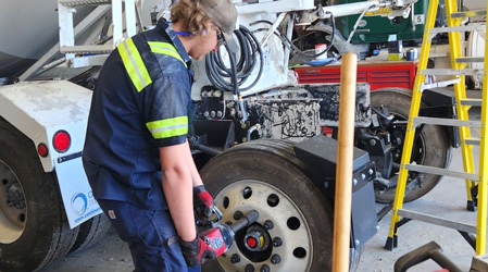 male working on air brakes on a truck