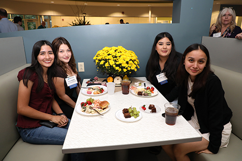 group of female students sitting at a table