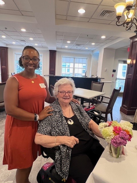 African american woman standing next to older white woman 